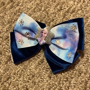 Blue frozen Elsa bow with navy blue felt background
